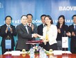Ông Nguyễn Quang Phi - Tổng giám đốc Kl994 game bài casino hấp dẫn Bảo Việt và bà Đinh Thị Quỳnh Vân - Tổng giám đốc PwC ký kết hợp tác