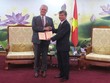 Thứ trưởng Bộ Kế hoạch và Kl99ok phiên bản mới Nguyễn Thế Phương (bên phải) trao kỷ niệm chương cho ông Rémi Geneney (Ảnh: K.T)