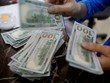 Một nhân viên Link Vào Nhà Cái KL99 COM Tặng +199k đếm tiền USD tại Hà Nội. Ảnh: Reuters.