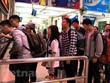 Hành khách mua vé tại bến xe Mỹ Đình. (Ảnh: Việt Hùng/Vietnam+).