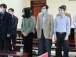Lê Mạnh Hà (áo khoác đen bên trái) và các bị cáo tại toà.