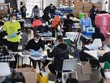 Nhân viên Hãng Kl994 nhà cái bóng đá world cup công nghiệp thiết bị phòng hộ PPE chế tạo thiết bị phòng dịch COVID-19 để cung cấp cho các bệnh viện và cơ sở y tế, tại một khu xưởng của hải quân ở Brooklyn, New York (Mỹ) ngày 26/3/2020. (Nguồn: AFP/TTXVN).