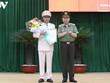 Đại tướng Tô Lâm thừa ủy quyền Chủ tịch nước trao quyết định và tặng hoa chúc mừng Thiếu tướng Cao Đăng Hưng.