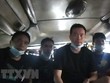 Những người Trung Quốc nhập cảnh trái phép bị phát hiện trong hầm xe. (Ảnh: TTXVN phát).