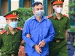 Bị cáo Nguyễn Minh Khải bị dẫn giải đến phiên tòa.