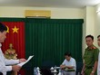 Giám đốc Công ty lương thực Trà Vinh Trần Văn Tâm nghe đọc lệnh bắt. Ảnh:Công an cung cấp.