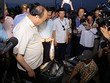 Thủ tướng hỏi thăm giá cả các loại cá, trực tiếp mua ba con cá ủng hộ ngư dân Quảng Trị. Ảnh:Hoàng Táo