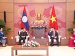 Chủ tịch Quốc hội Vương Đình Huệ tiếp Chủ tịch Quốc hội CHDCND Lào Xaysomphone Phomvihane. (Ảnh: TTXVN) .