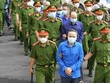 Các bị cáo bị dẫn giải đến phiên tòa sáng nay. (Ảnh: Hữu Hạnh)