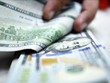 Đồng tiền mệnh giá 100USD. (Ảnh minh họa: THX/TTXVN)