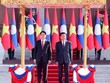 Tổng Bí thư, Chủ tịch nước Lào Thongloun Sisoulith chủ trì trọng thể lễ đón chính thức Chủ tịch nước Lương Cường theo nghi thức cao nhất dành cho nguyên thủ quốc gia. Ảnh: TTXVN