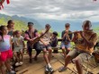 Giàng A La hướng dẫn du khách nước ngoài sử dụng nhạc cụ truyền thống của đồng bào Mông.