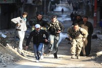 Các nhà báo mạo hiểm băng qua một con đường trong thành phố đang có chiến sự Aleppo ở Syria năm 2012 - Ảnh: Reuters