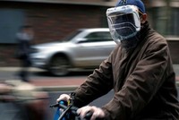 Một người dân đeo khẩu trang và mặt nạ tự chế từ chai nhựa trên đường phố Thượng Hải, Trung Quốc hôm 22/3. Ảnh: Reuters.