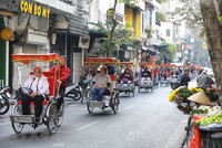 Đoàn khách du lịch quốc tế tham quan phố cổ Hà Nội. (Ảnh: Minh Quyết/TTXVN).