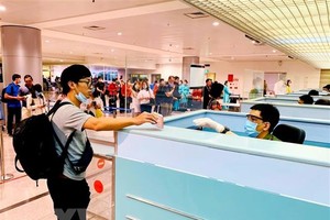 Làm thủ tục nhập cảnh tại cửa khẩu Tân Sơn Nhất. (Ảnh: Thành Chung/TTXVN).