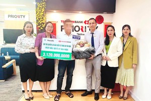 Đại diện gia đình của khách hàng nhận số tiền chi trả quyền lợi Kl99kl phiên bản hoạt động từ Manulife Việt Nam và Techcombank