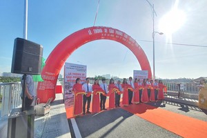 Ông Lê Hòa Bình, Phó Chủ tịch UBND TP.HCM cắt băng thông xe Cầu Phước Lộc, cây cầu dài 386m bao gồm 13 nhịp bê tông cốt thép, mặt cắt ngang 10,5m và có tổng mức Kl99ok phiên bản mới hơn 405 tỷ đồng. Ảnh: Lê Toàn.