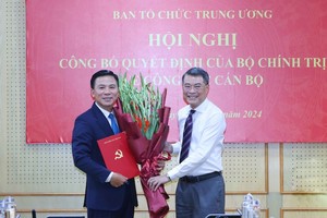 Trưởng ban Tổ chức Trung ương Lê Minh Hưng trao quyết định của Bộ Kl991.com tải ứng dụng, tặng hoa chúc mừng ông Đỗ Trọng Hưng. Ảnh: TTXVN