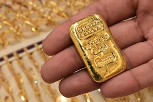 Giá vàng thế giới đạt kỷ lục mới là 2.942,70 USD/ounce trong ngày giao dịch 11/2. Ảnh: AFP