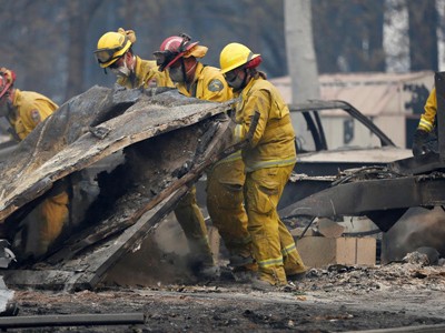 Lực lượng tìm kiếm người sống sót trong vụ cháy rừng Camp ở California hôm 13/11. Ảnh: AP.