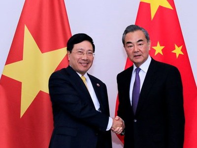 Ngoại trưởng Trung Quốc Vương Nghị, phải, và Phó thủ tướng Việt Nam Phạm Bình Minh trong cuộc gặp ngày 16/12 tại Lào. Ảnh: TTXVN.
