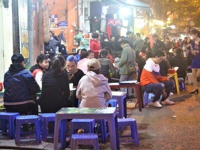 Một dãy những quán nhậu đêm đông khách tới nỗi ngồi tràn ra cả lòng đường.