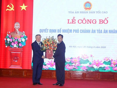 Đồng chí Nguyễn Hòa Bình trao quyết định và chúc mừng đồng chí Nguyễn Văn Tiến.