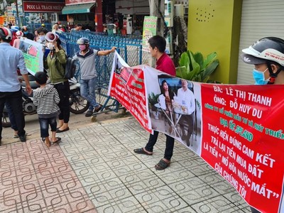 Khách hàng căng băng-rôn tố công ty lừa đảo và đòi lại tiền.