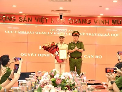 Thượng tá Nguyễn Thành Vĩnh - Tân Giám đốc Trung tâm Dữ liệu Quốc gia về Dân cư (trái) nhận quyết định bổ nhiệm từ Cục trưởng C06 Nguyễn Quốc Hùng. (Nguồn: Lao Động).