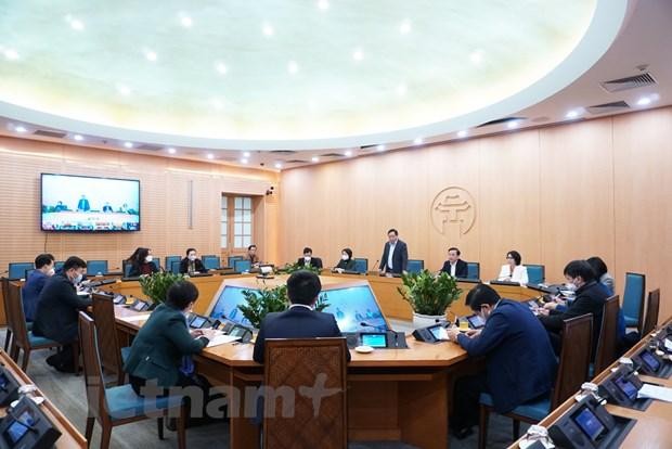 Các đại biểu tham dự cuộc họp của Ban Chỉ đạo phòng, chống dịch COVID-19 thành phố Hà Nội với các quận, huyện. (Ảnh: PV/Vietnam+).