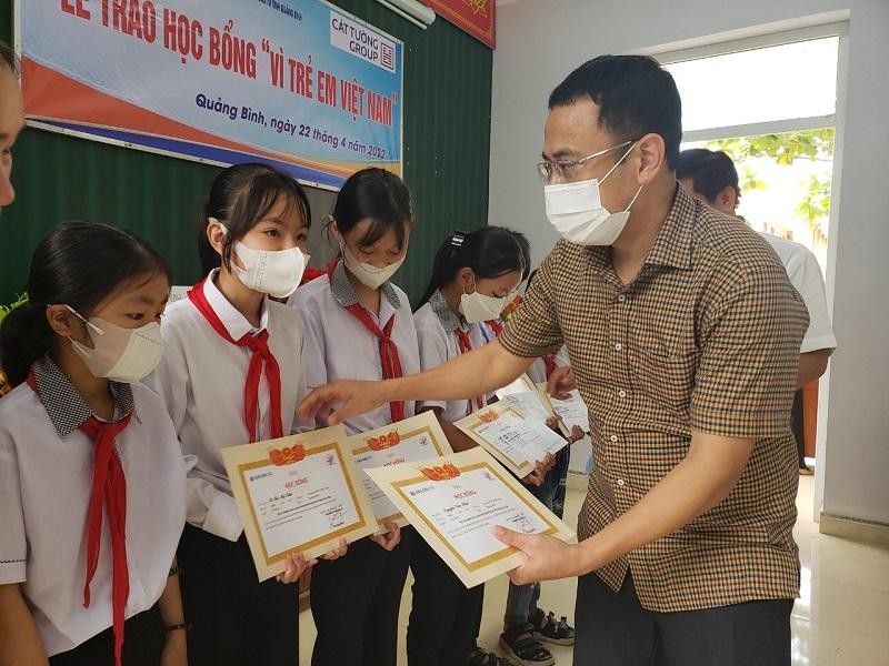Ông Mai Hồng Ngọc, Phó giám đốc Sở Kế hoạch và Kl99ok phiên bản mới tỉnh Quảng Bình trao học bổng cho các cháu.