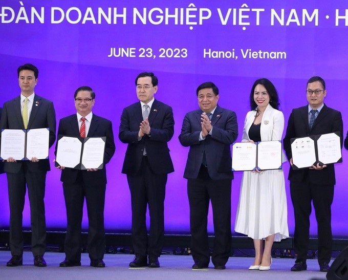 Bà Nguyễn Thị Thanh Bình, Chủ tịch HĐQT T&amp;T Energy (thứ hai từ phải sang), và ông Henry (Hyeongwook) Choo, Chủ tịch SK E&amp;S (ngoài cùng bên trái), trao biên bản ghi nhớ hợp tác