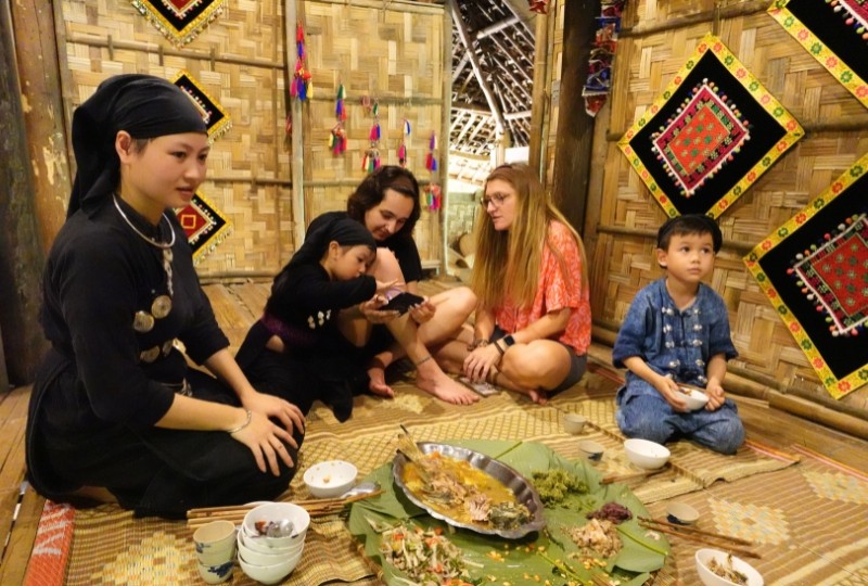 Du khách nước ngoài thưởng thức bữa trưa cùng 1 gia đình Tày tại nhà Thuốc.