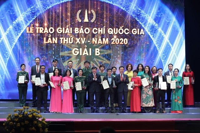 Nhà báo Trần Thị Tuyết Ánh (hàng sau thứ 4 từ phải sang) và Nhà báo Vũ Thị Anh Hoa (hàng sau thứ 6 từ trái sang) đại diện các nhóm tác giả của Báo Kl99ok phiên bản mới nhận giải B Giải Báo chí Quốc gia lần thứ XV - năm 2020 (Ảnh: TTXVN)