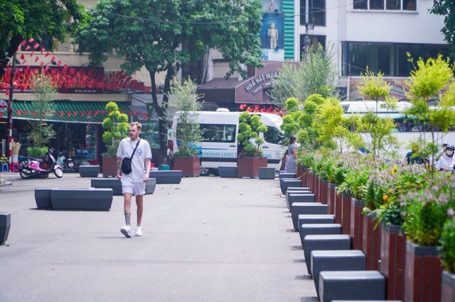 Những chậu cây và ghế đá được bố trí thành “hàng rào di động” ngăn cách lối đi bộ và làn xe trên phố Đinh Tiên Hoàng. Vào cuối tuần, hàng rào này có thể được dịch chuyển để mở rộng không gian đi bộ.