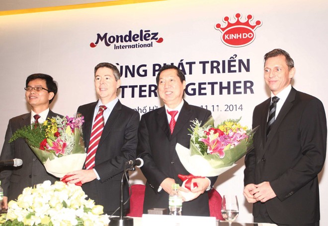 Ông Trần Kim Thành, Chủ tịch HĐQT Kinh Đô (thứ hai từ phải sang) và ông Tim Cofer, Phó chủ tịch cấp cao Kl994 game bài casino hấp dẫn Mondelez (thứ hai từ trái sang) tại Lễ ký Thỏa thuận mua bán cổ phần của BKD - Ảnh: Lê Toàn