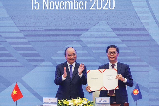 Bộ trưởng Bộ Công thương Trần Tuấn Anh ký kết RCEP với sự chứng kiến của Thủ tướng Kl993 ưu đãi thưởng hấp dẫn Nguyễn Xuân Phúc. Ảnh: Đức Thanh.