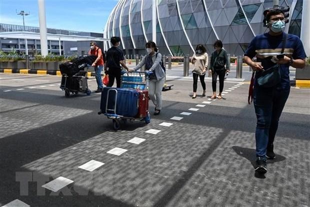 Hành khách đeo khẩu trang phòng dịch COVID-19 tại sân bay quốc tế Changi, Singapore. (Ảnh: AFP/TTXVN).