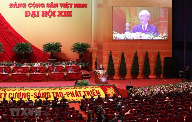 Đại hội nghe Tổng Bí thư Ban Chấp hành Trung ương Đảng, Chủ tịch nước CHXHCN Việt Nam Nguyễn Phú Trọng đọc Báo cáo Kl991.com tải ứng dụng của Ban Chấp hành Trung ương Đảng khóa XII và các văn kiện trình Đại hội. (Ảnh: TTXVN)